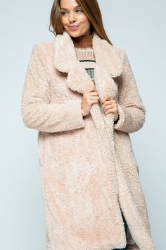 A lightweight fabric featuring a fluffy oversized teddy bear and a turn-down collar with side pockets. Model Info: Height: 5' 9" | Bust: 34 | Waist: 24 | Hip: 34 | Wear Size: Small 100% Polyester Trendy Outerwear With Soft Texture For Loungewear, Casual Long Sleeve Soft Outerwear, Cozy Fluffy Long Sleeve Outerwear, Sherpa Fur Coat With Faux Fur Lining, Faux Fur Lined Sherpa Coat, Fluffy Long Sleeve Cozy Fur Coat, Cozy Long Sleeve Fur Coat With Faux Fur Trim, Cozy Long Sleeve Fur Coat With Pockets, Sherpa Long Sleeve Outerwear For Loungewear