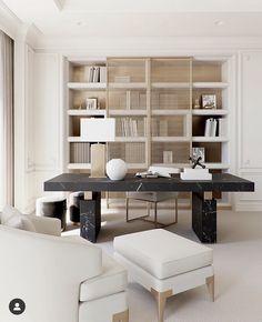 a living room filled with white furniture and bookshelves