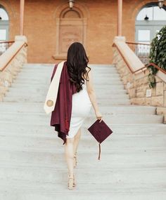 a pregnant woman walking down some steps