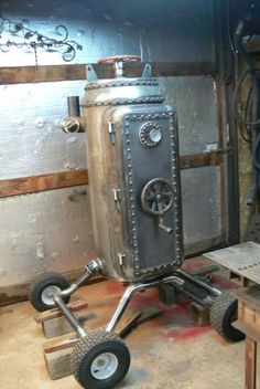 a metal object sitting on top of a dolly in a room filled with wooden pallets