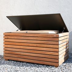 an open wooden box sitting on the ground