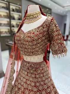 Elevate your style with our Maroon Bridal Lehenga BL-126. This exquisite lehenga is adorned with intricate gold and blush embroidery, adding a touch of opulence to your special day. Perfect for brides who want to make a statement with elegance and grace. Fabric: Velvet! WASH CARE INSTRUCTIONS - Please Dry clean only when it is applicable! Ready to Ship! Designer Kundan Lehenga With Intricate Embroidery, Traditional Gown With Dori Work In Chinon, Traditional Chinon Gown With Dori Work, Elegant Dola Silk Chandbali Lehenga, Elegant Embroidered Chinon Lehenga, Dola Silk Lehenga With Intricate Embroidery For Reception, Reception Lehenga With Intricate Embroidery In Dola Silk, Reception Dola Silk Lehenga With Intricate Embroidery, Elegant Choli With Dori Work For Reception