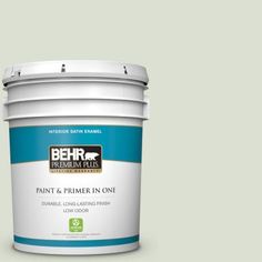 the behr paint and primer in one is shown on a gray background with white trim