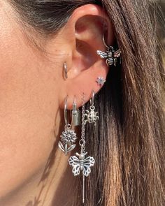 a close up of a person wearing some kind of earring with flowers on it