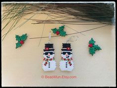 the bead christmas earrings are decorated with holly leaves and snowman's hats