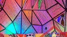 the inside of a tent with colorful lights and patterns on it's walls is shown