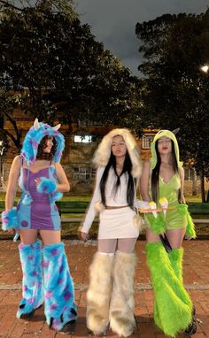 three women dressed in costumes standing next to each other