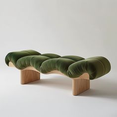 a bench made out of wood and green velvet