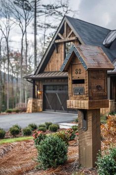 a wooden mailbox sitting in front of a house