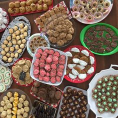 a table topped with lots of different types of desserts and pastries on plates