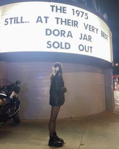 a woman standing in front of a sign that says, still at their very best dora jar sold out