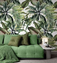 a green couch sitting in front of a wall mural