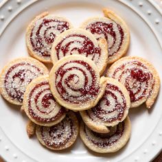 a white plate topped with cookies covered in powdered sugar