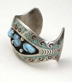 Vintage large silver with turquoise nugget and coral inlay cuff bracelet-Amazing Navajo artisan handmade cuff-3 large turquoise nuggets surrounded by crushed turquoise and coral inlay in a waves design-Cuff is marked with a pictomark that matches that of artist Charlie Singer, arrowhead mark-Cuff is not marked sterling but acid test shows high silver content - red stain appears with nitric acid test-Cuff is rigid, stamp designs at the ends of the cuff-Very good vintage condition, with patina con Southwestern Turquoise Cuff Bracelet With Inlay, Southwestern Style Turquoise Cuff Bracelet With Inlay, Southwestern Inlay Cuff Bracelet Gift, Bohemian Turquoise Inlay Cuff Bracelet, Vintage Cuff Bracelet, Beach Icon, Red Stain, Vintage Navajo, Turquoise Cuff