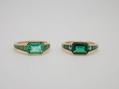 At the centerpiece of this lab grown Zambian emerald ring is a radiant 1.5 ct emerald, set east west to highlight its natural allure. Flanking it are calibre cut emeralds, each uniquely shaped to create a seamless gradient effect, making every ring truly one-of-a-kind. Set in luxurious 18K yellow gold, this ring exudes timeless charm. What makes it truly special? Calibre cut stones are individually shaped to fit precisely into the design, resulting in a mesmerizing display of color and brillianc Green Emerald-cut Channel Set Jewelry, Emerald Channel Set Jewelry With Emerald Cut, Emerald Cut Channel Set Emerald Jewelry, Channel Set Emerald Cut Emerald Ring, Green Emerald Ring With Channel Set As A Gift, Emerald Cut Emerald Ring Channel Set, Emerald Cut Channel Set Emerald Ring, Colombian Emerald Ring, Emerald Set