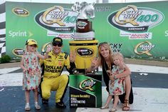 a man and two children posing with a trophy