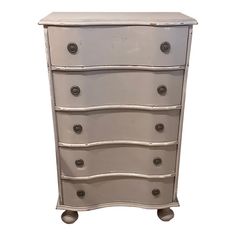 an antique chest of drawers with silver paint and metal knobs on the bottom drawer