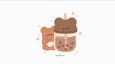 two brown teddy bears sitting next to a cup with liquid in it and stars on the side