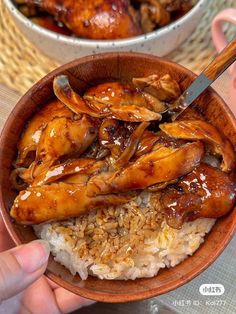 two bowls filled with rice covered in sauce and chicken wings on top of each other