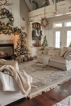 a living room decorated for christmas with white furniture and garlands on the fireplace mantel