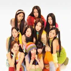 a group of young women sitting next to each other in front of a white background