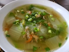 a white bowl filled with soup on top of a table