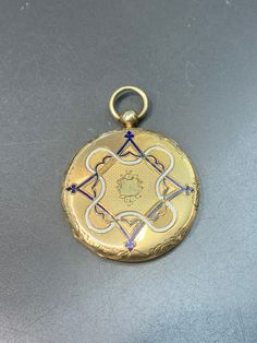 Measurement: 5.5 cm by 4.5 cm by 0.7 cm Metal: 14k Gold Weight: 16.7 Grams *Some enamel missing on not sides of locket Luxury Blue Locket Jewelry, Blue Enamel Locket Jewelry, Blue Medallion Jewelry For Anniversary, Luxury Blue Medallion Jewelry, Blue Hallmarked Medallion Jewelry, Blue Engraved Jewelry For Ceremonial Occasion, Ceremonial Blue Engraved Jewelry, Blue Heirloom Enamel Jewelry, Formal Blue Locket Jewelry