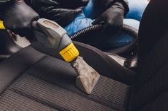 a close up of a car seat with a tool in it's pocket and people sitting behind