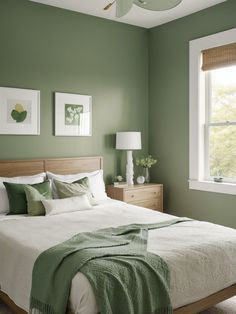 a bedroom with green walls and white bedding