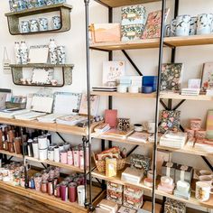 the shelves are filled with many different types of cards and other decorative items on them