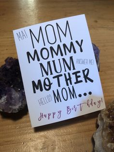 a mother's day card sitting on top of a table next to some rocks