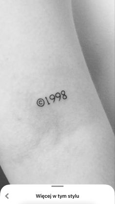 a small wrist tattoo with the number 999 on it's left side ribcage