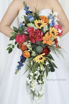 a bridal holding a bouquet of flowers and greenery