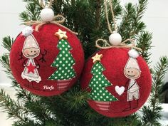 two red ornaments hanging from a christmas tree with white and green polka dot decorations on them