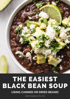 a bowl filled with black bean soup and topped with avocado