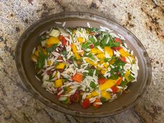 a bowl filled with vegetables on top of a counter