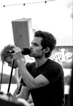 a man holding a microphone up to his face