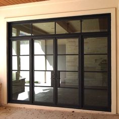 an empty room with glass doors on the outside