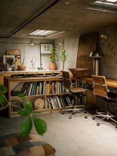 a home office with bookshelves, desks and chairs in the middle of it