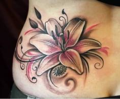 a woman's stomach with a flower tattoo on it