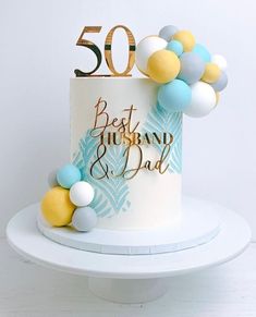 a 50th birthday cake with balloons and the number 50 on it