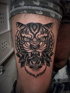 a man with a tiger tattoo on his leg