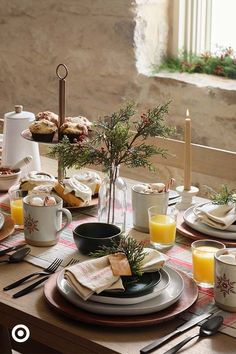 a table set with plates, cups and utensils