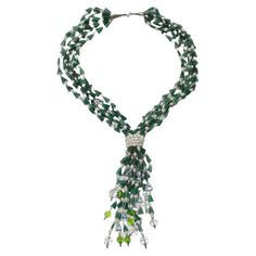 Do not miss out on this amazing 1980s multi-strand necklace! A plethora of green and white semi-precious stones beaded onto a variety of strands are joined at the center by wrap-around pearls to create this unique and eye catching necklace! The strands cascade down from the pearls to reveal more bright green and clear beads as the finishing touch. This necklace is so glamorous and stylish! Style this with a pearl Gucci handbag, a John Galliano dress and some Christian Louboutin heels to complete John Galliano Dress, Galliano Dress, Gucci Handbag, Clear Beads, Christian Louboutin Heels, Louboutin Heels, Semi Precious Stone, John Galliano, Semi Precious Stones