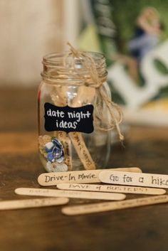 some wooden spoons are next to a jar with writing on it and two tags that say date night ideas