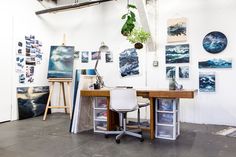 an art studio with paintings on the wall