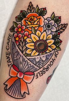 a woman's arm with flowers and words on it