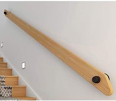 there is a wooden rail on the wall next to some stairs with black knobs