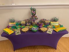 a purple table topped with lots of candy