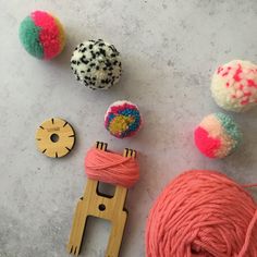 yarn, scissors and spools of thread on a table top with crafting supplies